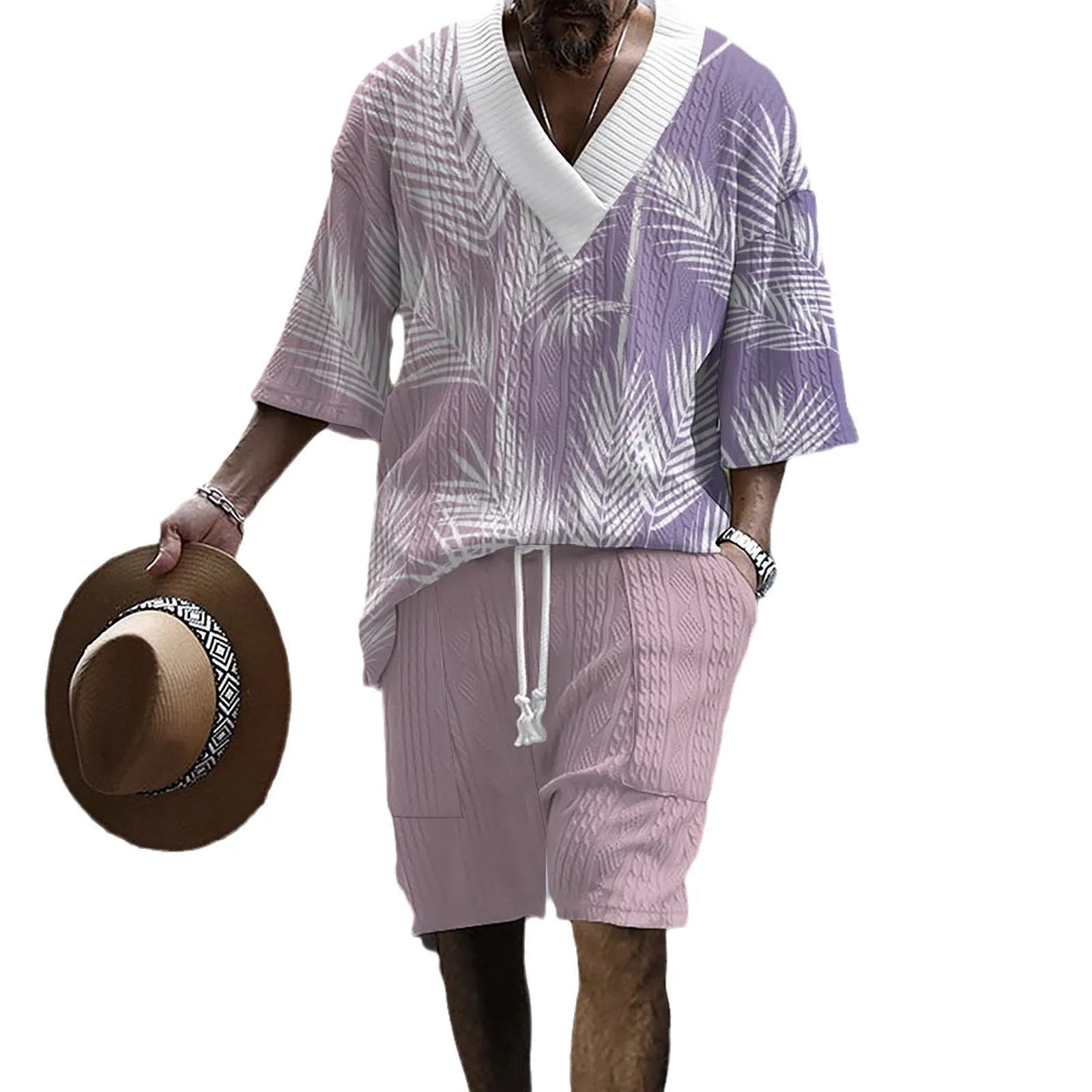 Man modelling a printed drop-shoulder knitted short-sleeved top with matching shorts in a casual setting.
