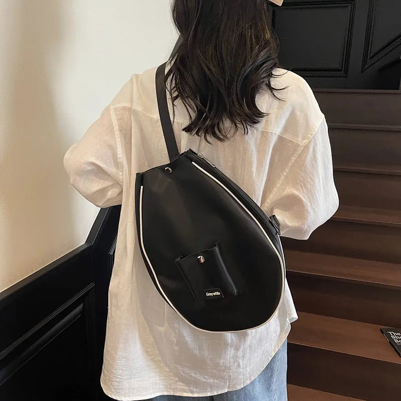 Black one-shoulder yoga storage bag showing large capacity and casual design