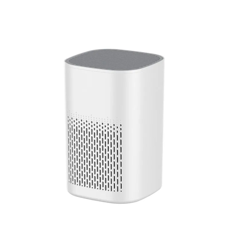 Compact desktop USB air purifier deodoriser with simple modern design on a desk.