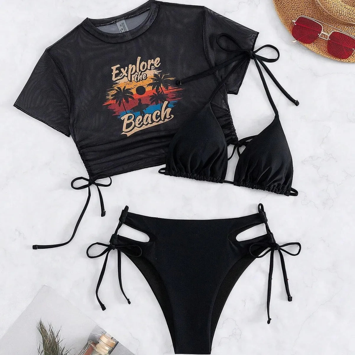 Women's three piece bikini swimsuit set in black, including bra, bottoms, and a short sleeved cover-up top.