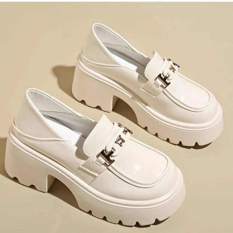 Black slip-on shoes with chunky square heel, round toe, and skull pattern on EVA upper