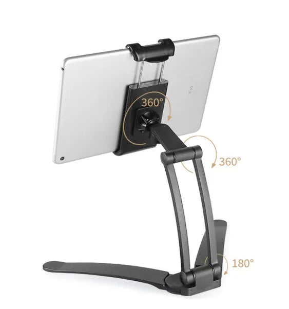 Silver aluminium desktop stand holding a tablet, showing 360-degree rotation and adjustable clamp mechanism.
