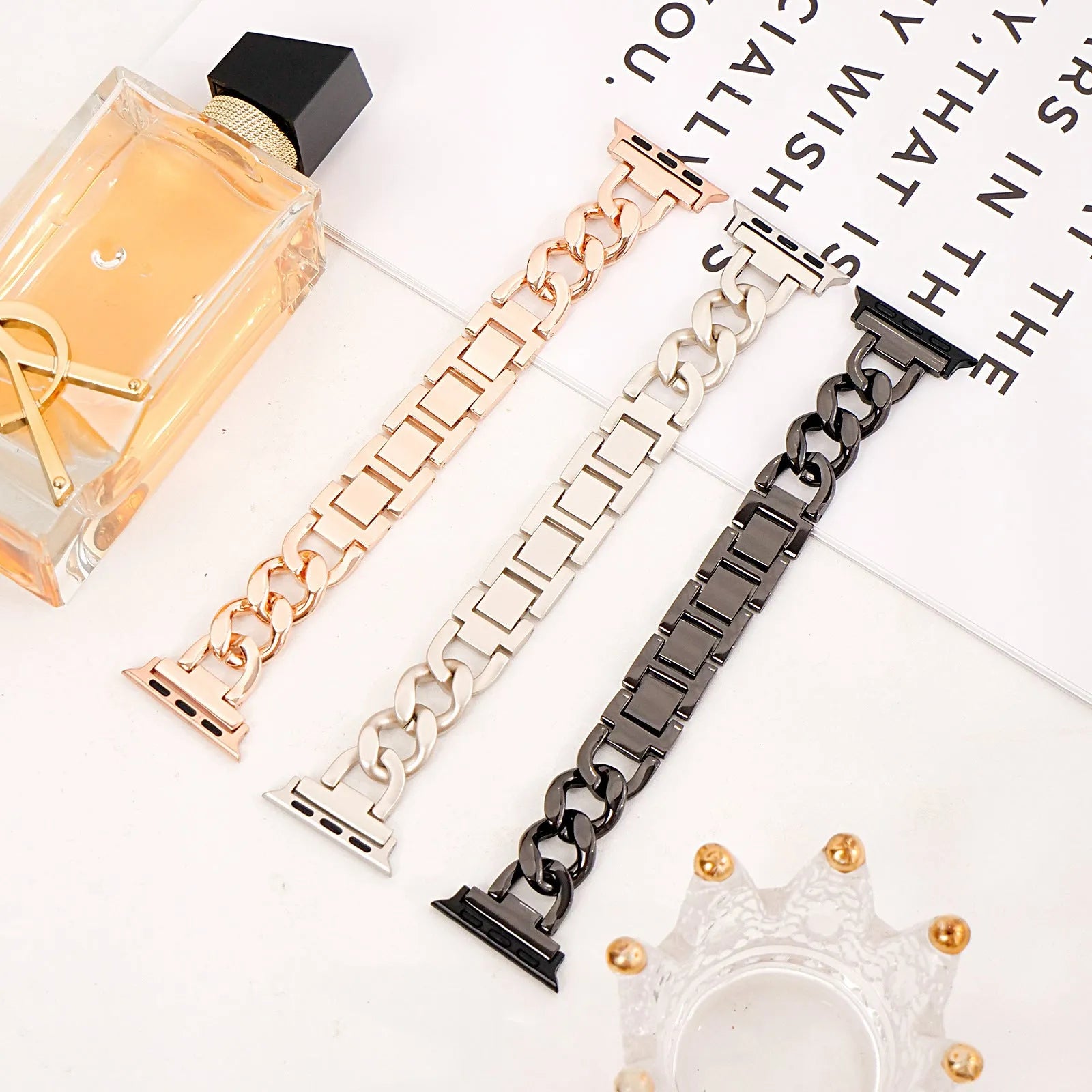 Metal denim chain watch strap for Apple Watch in multiple colours on a grey background.