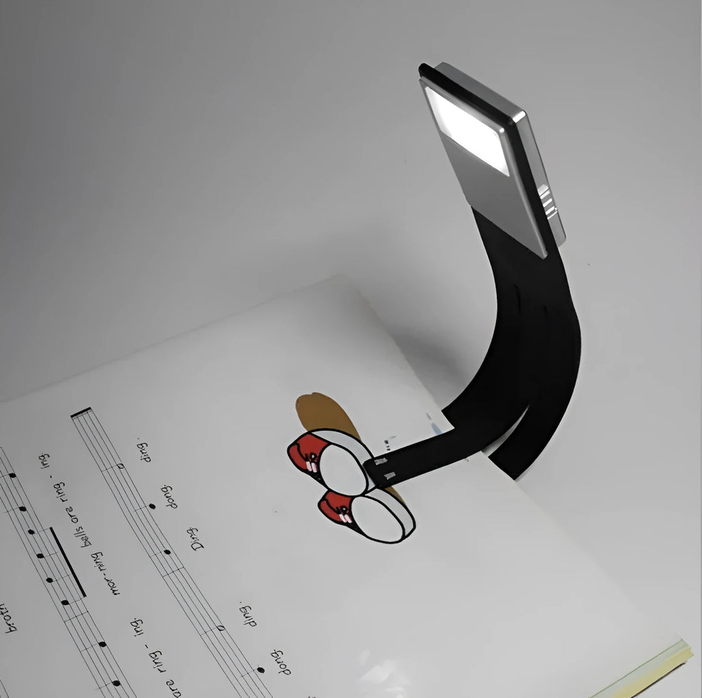 Black folding LED reading lamp showing compact folded design with USB charging port