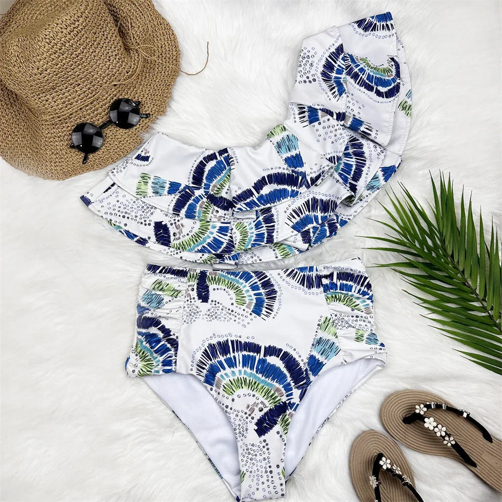 White women's one-shoulder swimsuit bikini with lotus leaf trim and high-leg split.