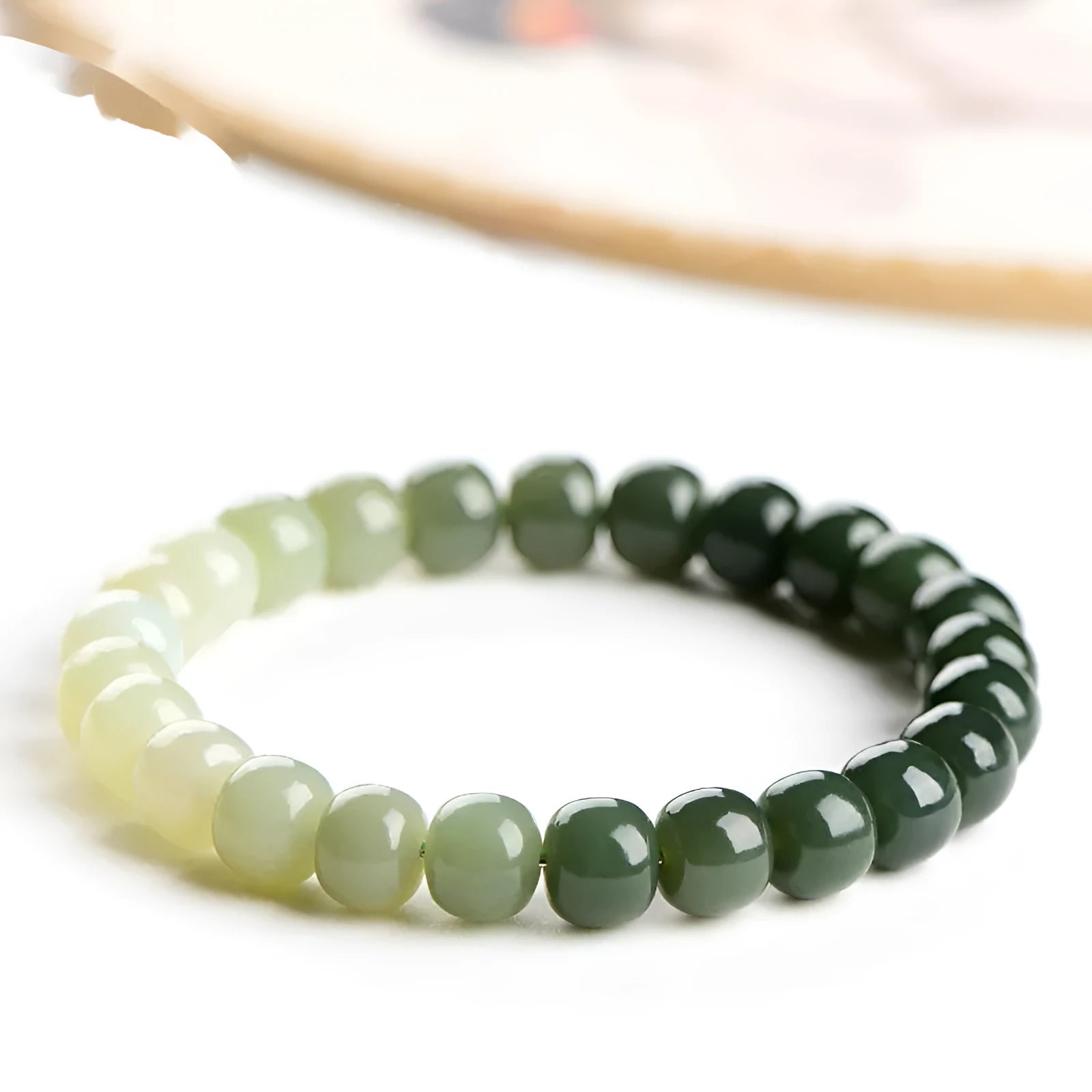 Natural Hetian jade bracelet with water gradient colour on polished beads.