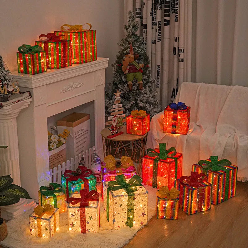 Set of three pre-lit Christmas gift box decorations with bows and LED lights for outdoor use