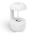 White anti-gravity humidifier showing water droplets levitating upwards from its mist outlet.
