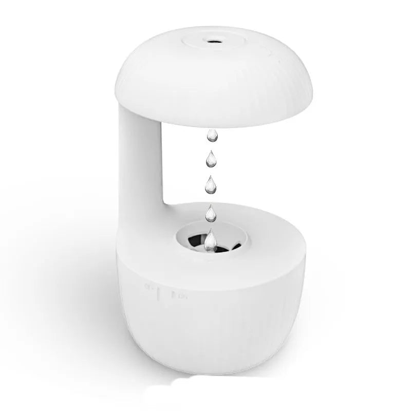 White anti-gravity humidifier showing water droplets levitating upwards from its mist outlet.