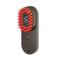 Pink and black smart massage comb with red light therapy for hair care