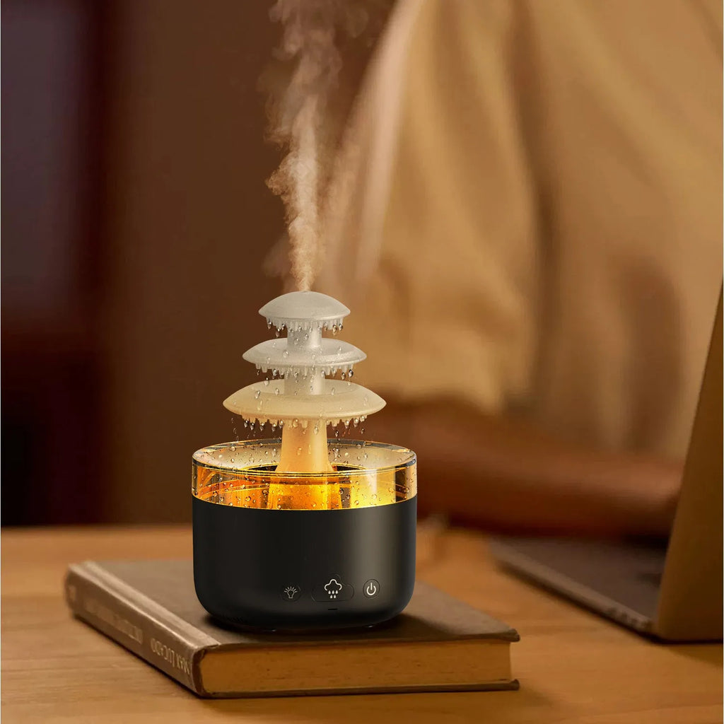 White Cloud Rain ultrasonic humidifier and essential oil diffuser with coloured LED lights on a table.