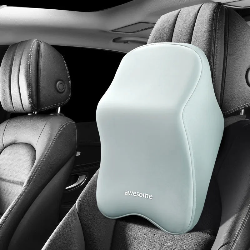 Black geometric pattern memory foam car lumbar pillow and matching headrest on a car seat.