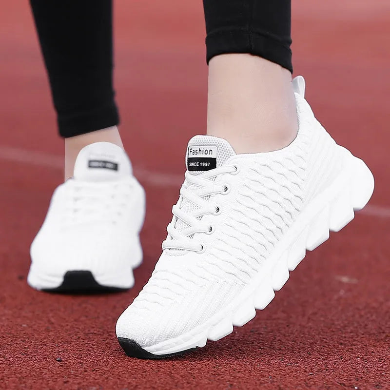 Women's running shoes in black, pink, or white with fly weaving upper and wear-resistant outsole.