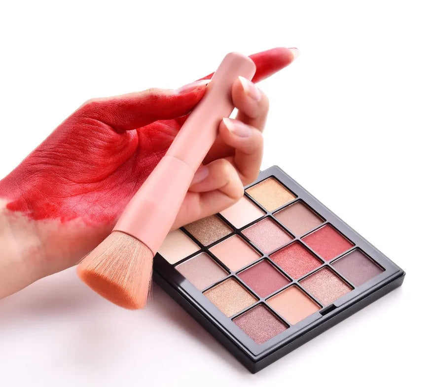 10-piece wooden handle makeup brush set including powder, foundation, eyeshadow, concealer, and lip brushes on pink background