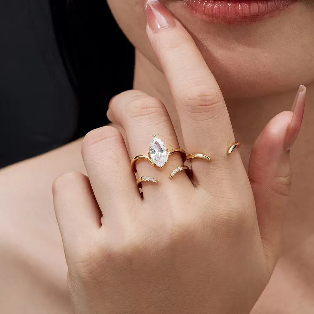 Gold zinc alloy three-piece geometric ring set with horse eye inlay on white background