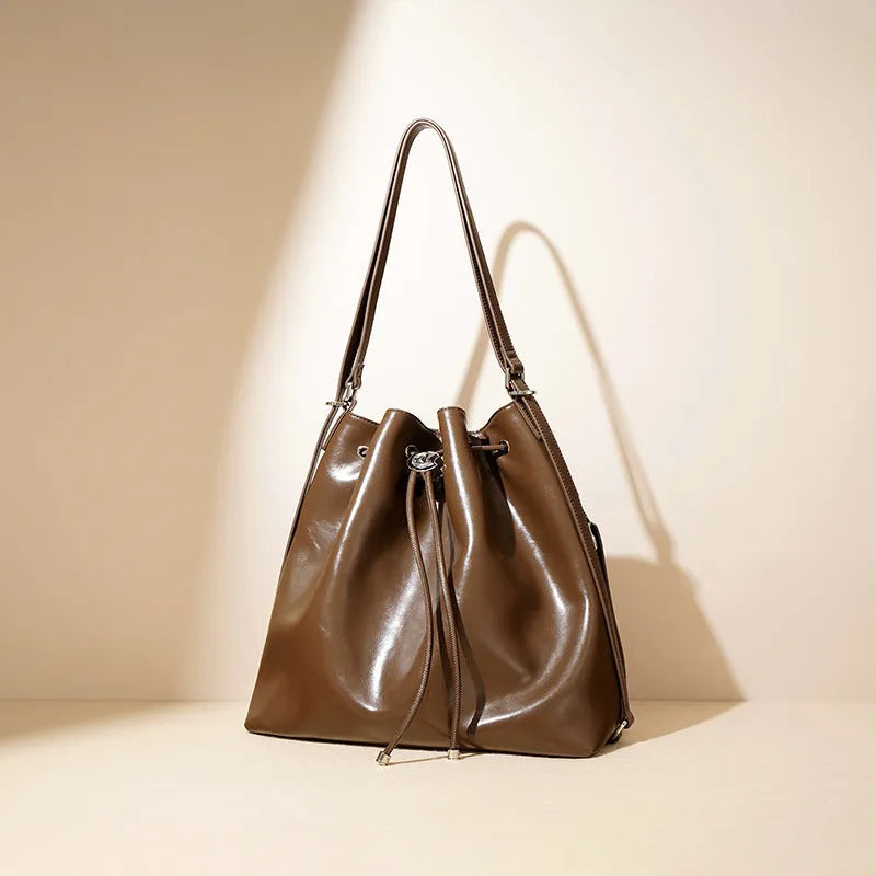 Genuine leather women's bucket bag with one shoulder strap in a retro style.