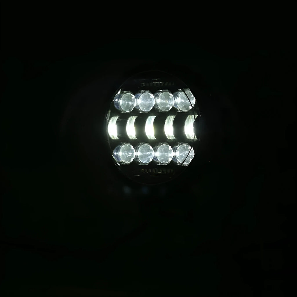 7-inch circular LED car headlight with black die-cast aluminium housing and PMMA lens on dark background