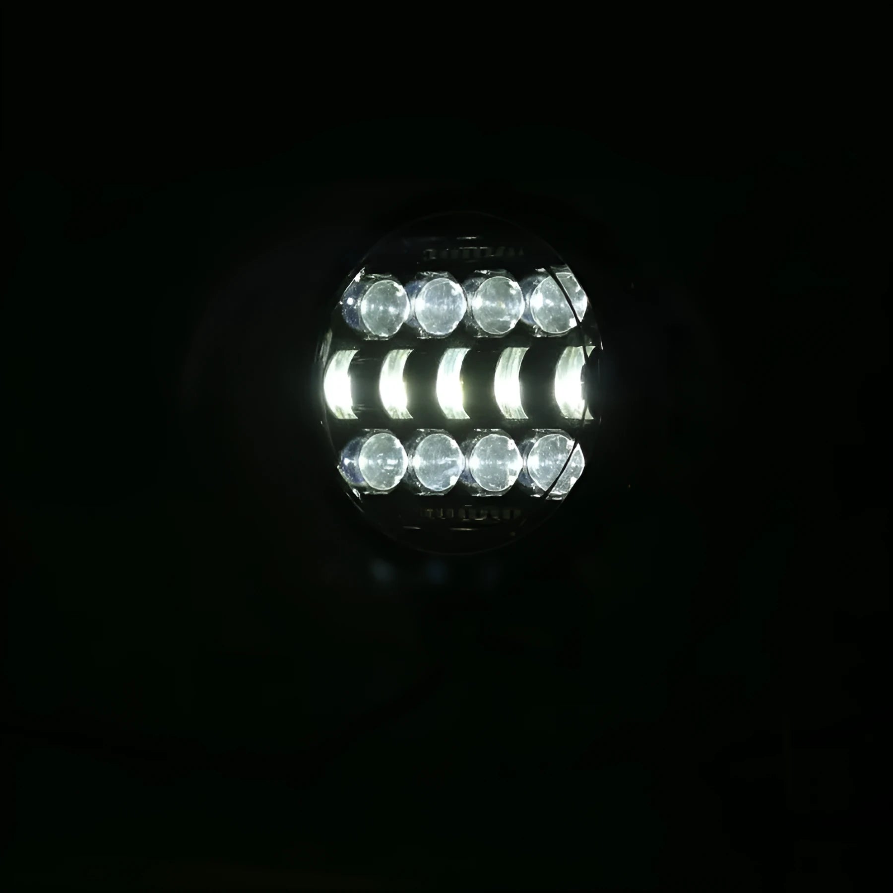 7-inch circular LED car headlight with black die-cast aluminium housing and PMMA lens on dark background