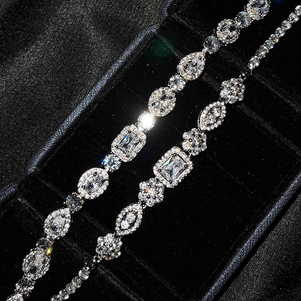 Close-up of a women's geometric silver bracelet with sparkling inlaid zircon stones and a lobster clasp.