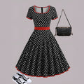 Women's multicolour polka dot dress with a square collar, short sleeves, and a pleated mid-length skirt.