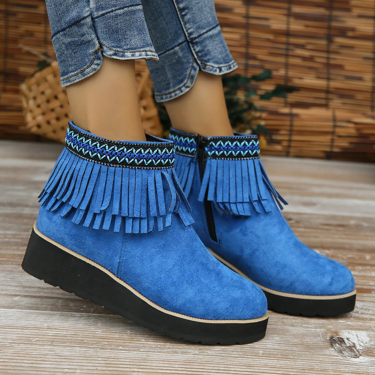 Women's dark brown suede ankle boots with a wedge heel, thick platform sole, tassel detail, and side zipper.