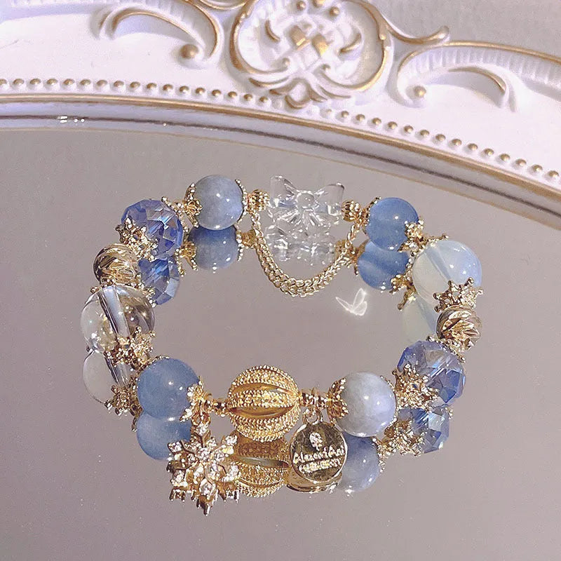 Women's bracelet with snowflake pendant and bow charm in galaxy colour