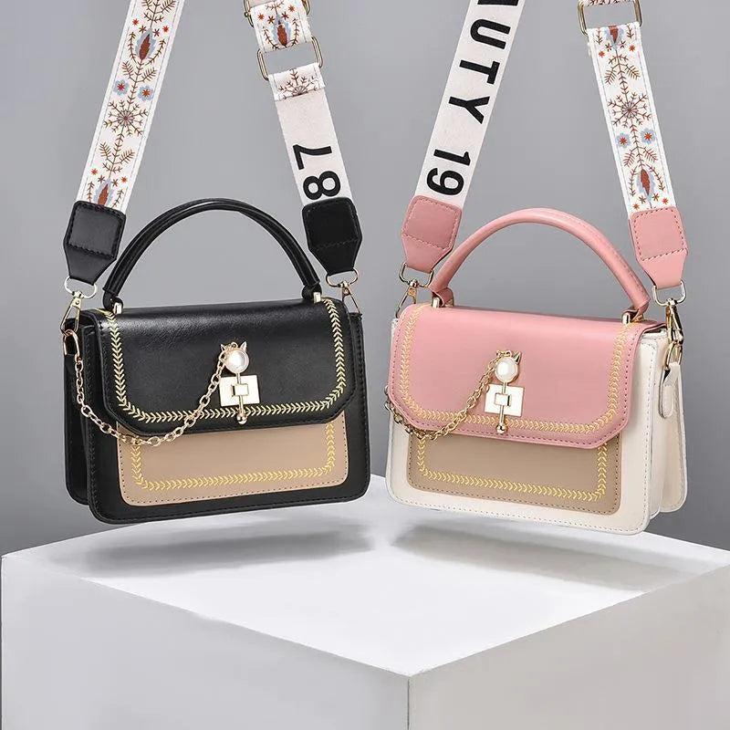 Large capacity PU shoulder bag with wide strap, embroidery detail, and contrast colour in black