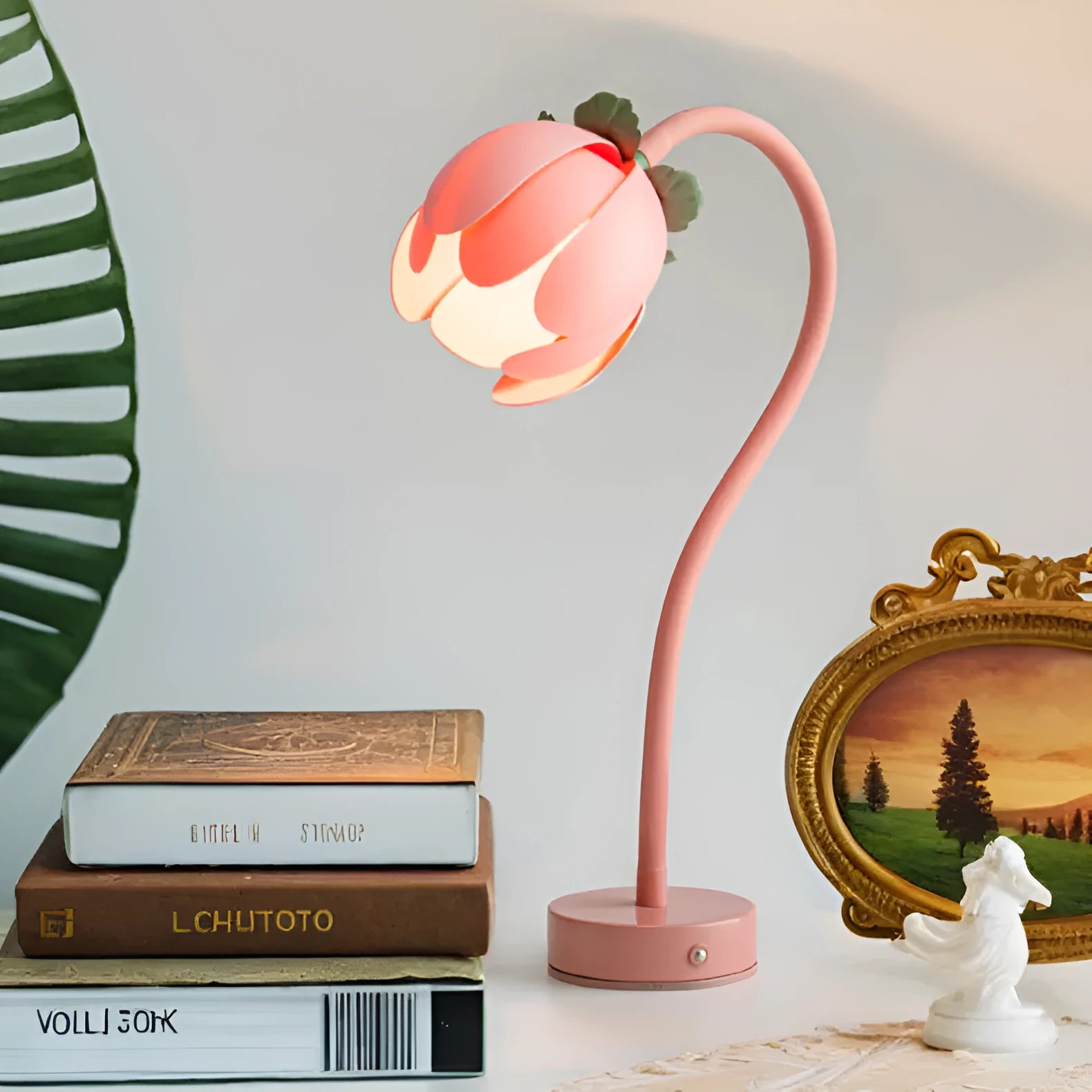 LED wireless charging night light with touch switch in pink showing tricolour light mode on bedside table