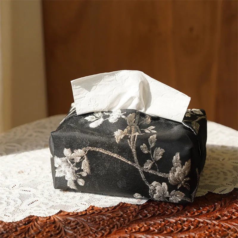 White Chinese brocade tissue box cover with embroidered plum blossoms, showing pearl buckle and plain opening options.