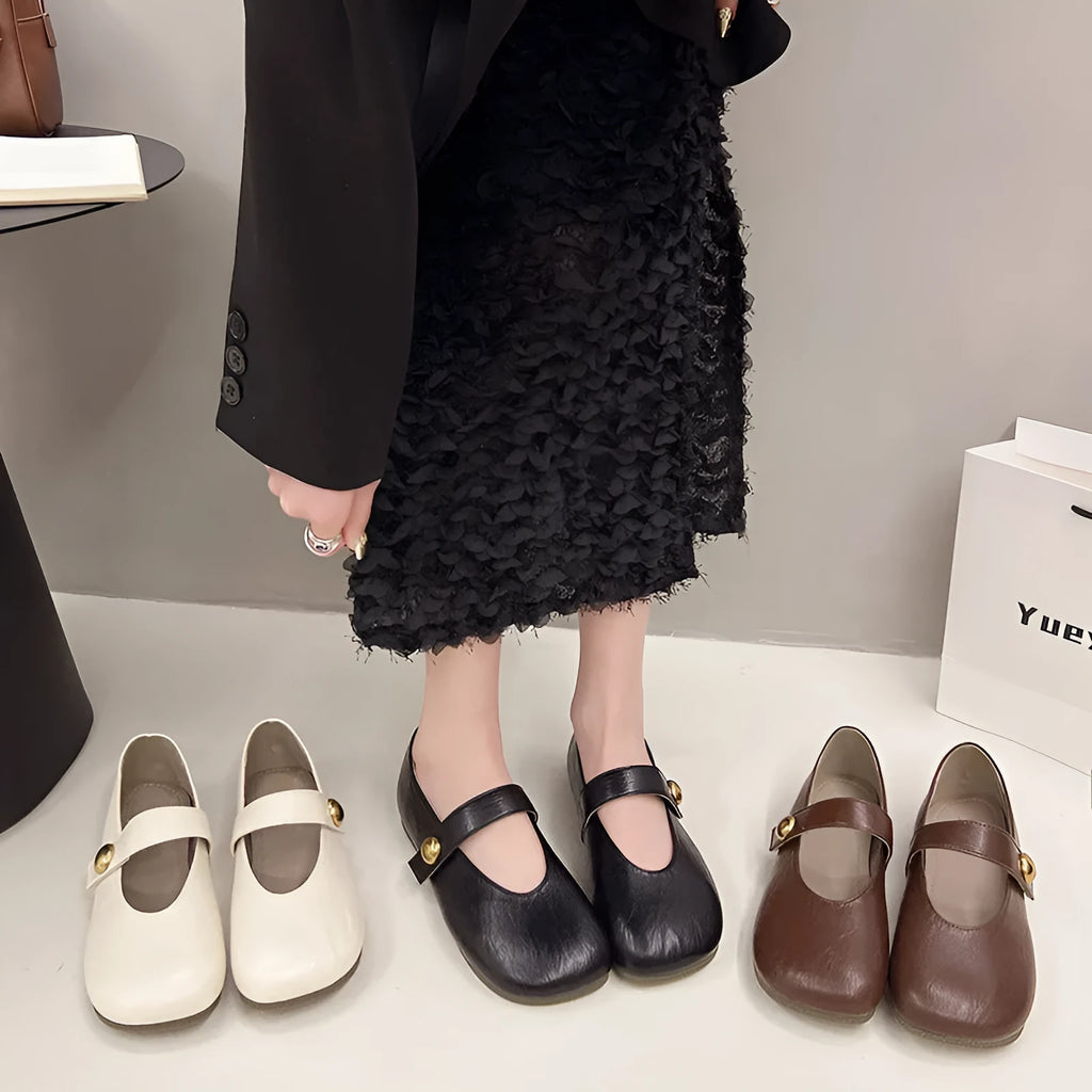 Women's casual flat heel buckle pumps in black with round toe and belt buckle detail