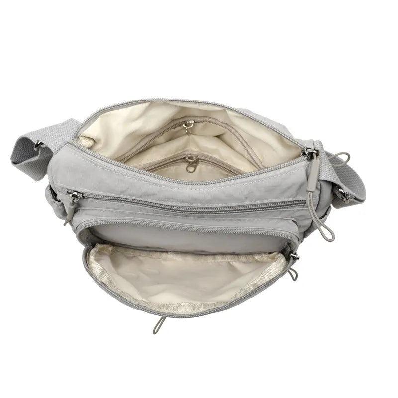 Water-repellent nylon crossbody bag with three-dimensional pocket shown in grey colour