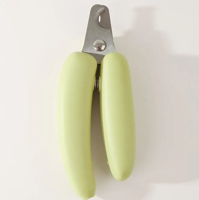 Banana-shaped pet nail clippers in green with metal blades for dog and cat grooming