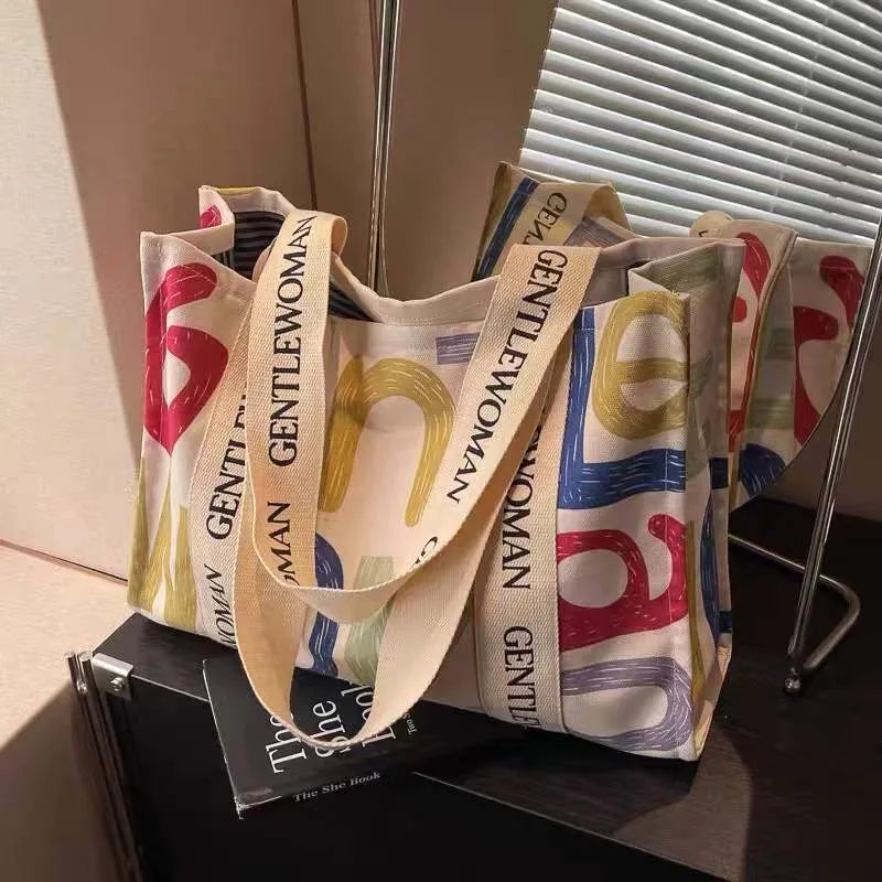 Large canvas women's tote bag with printed design options including letters and patterns