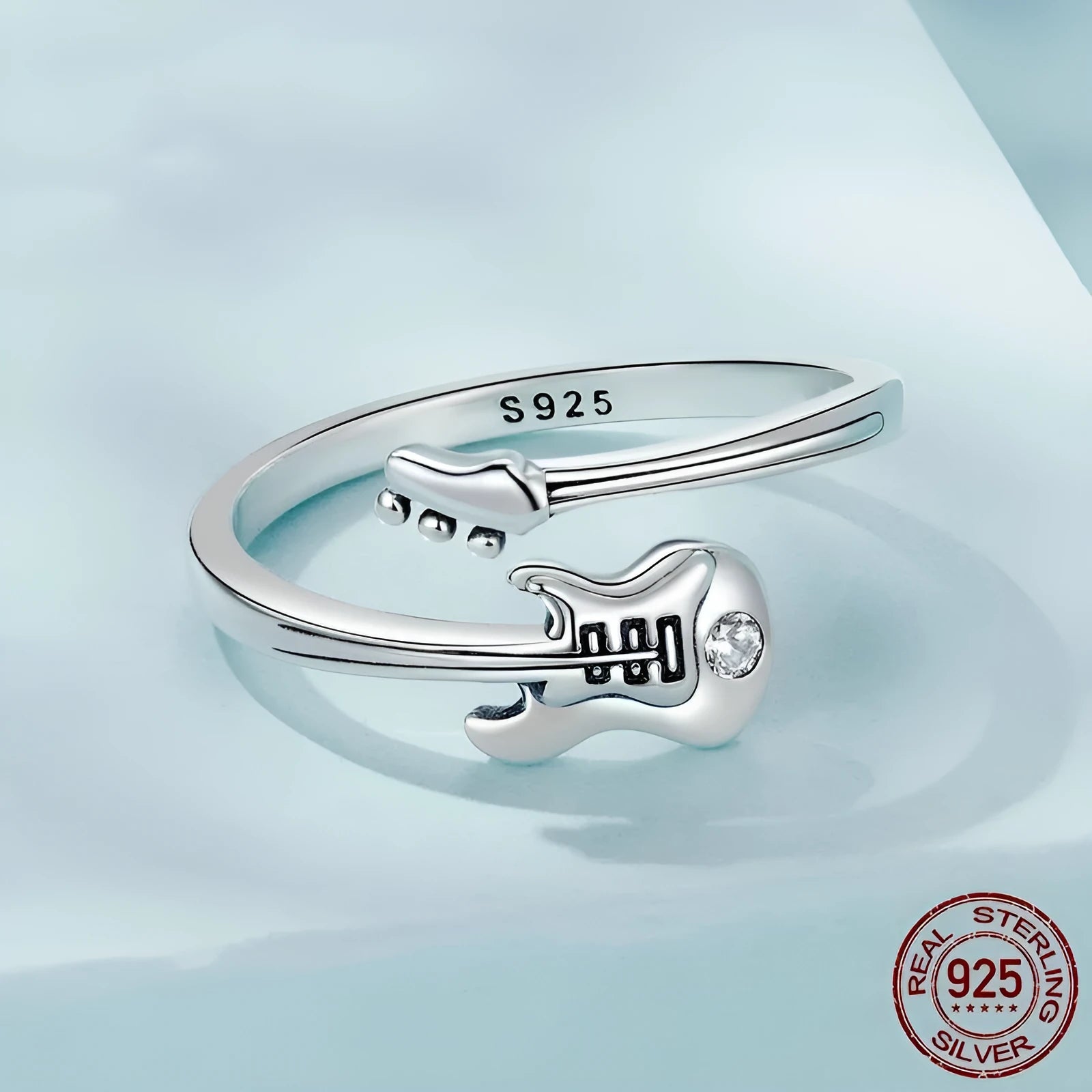 S925 silver oxidised open ring with guitar ornament on neutral background