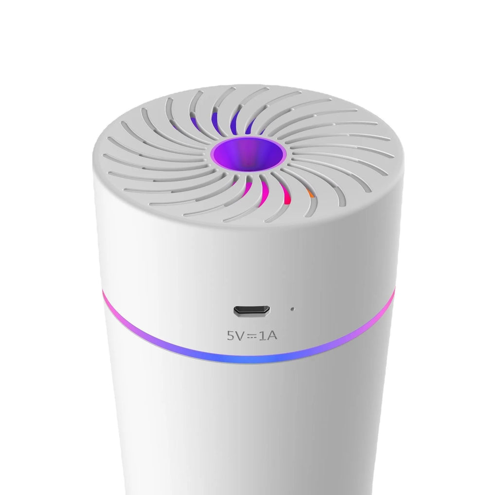 A small white or black USB car humidifier with aromatherapy function on a car dashboard.