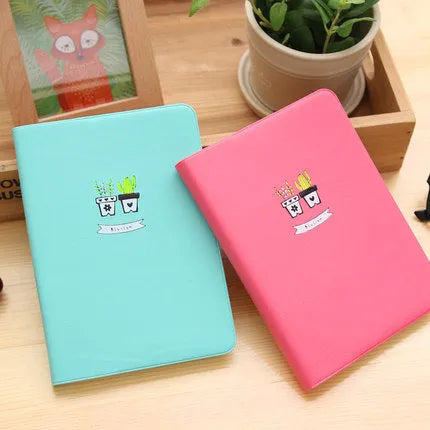 Leather A5 notebook with elastic strap closure showing beige paper pages in blue cover option
