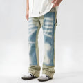Yellow and blue patchwork distressed denim jeans with a mid-rise waist and zip fly.