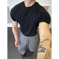 Men's knitted slim fit T-shirt in solid colour with cuff-closing short sleeves