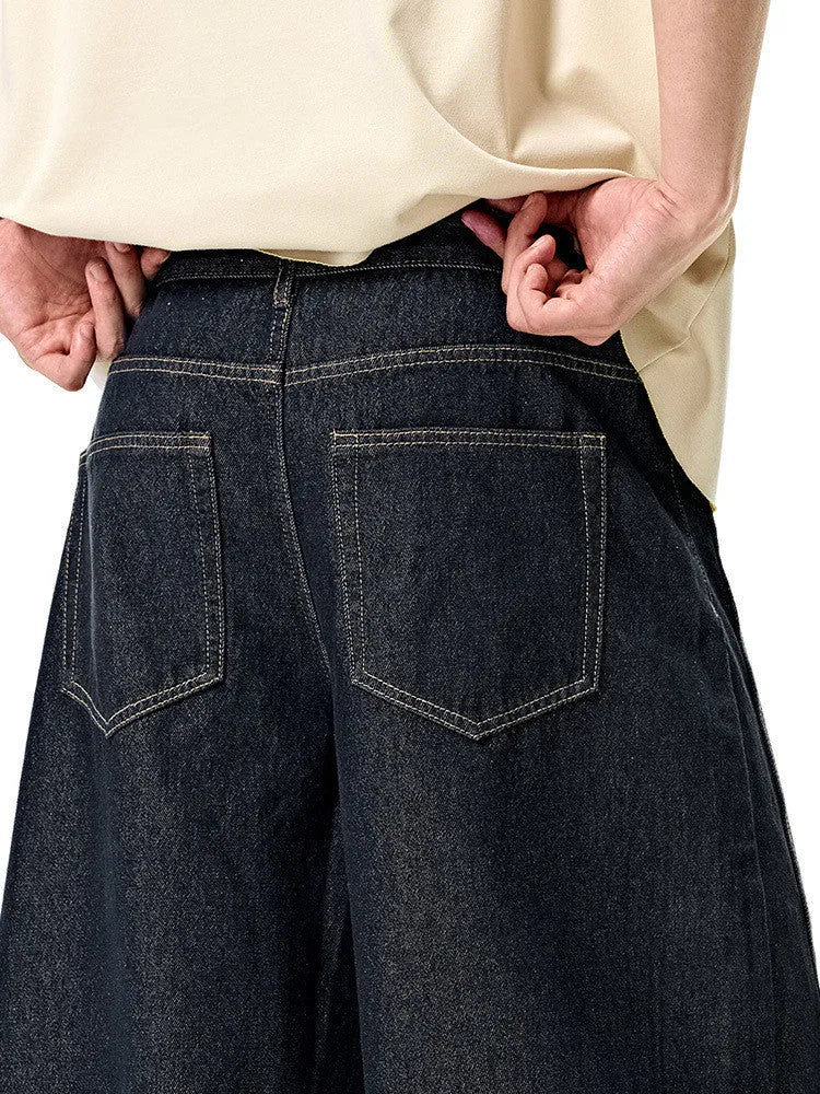 Men's wide leg denim trousers in original cow colour showing mid waist design and relaxed fit