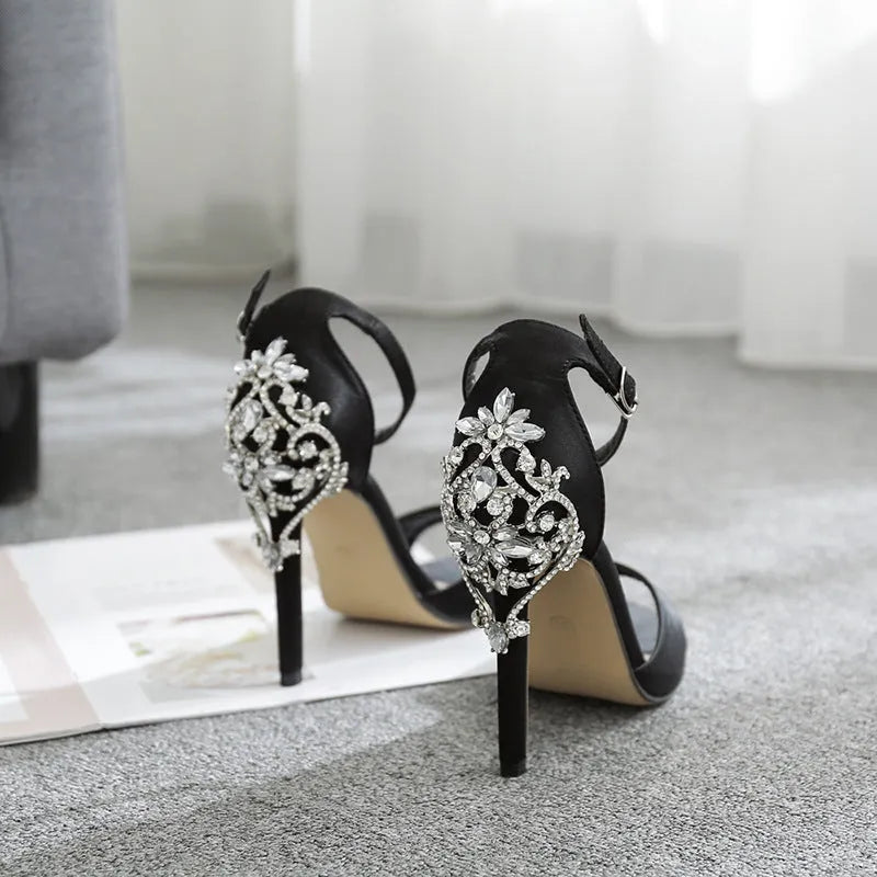 Black suede women's high heels with rhinestone details and a fish mouth toe.