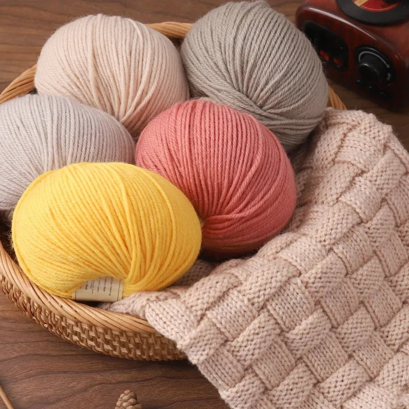 A roll of hand-knitting wool yarn in one of 30 colours, such as beige camel or rose red, for baby clothes.