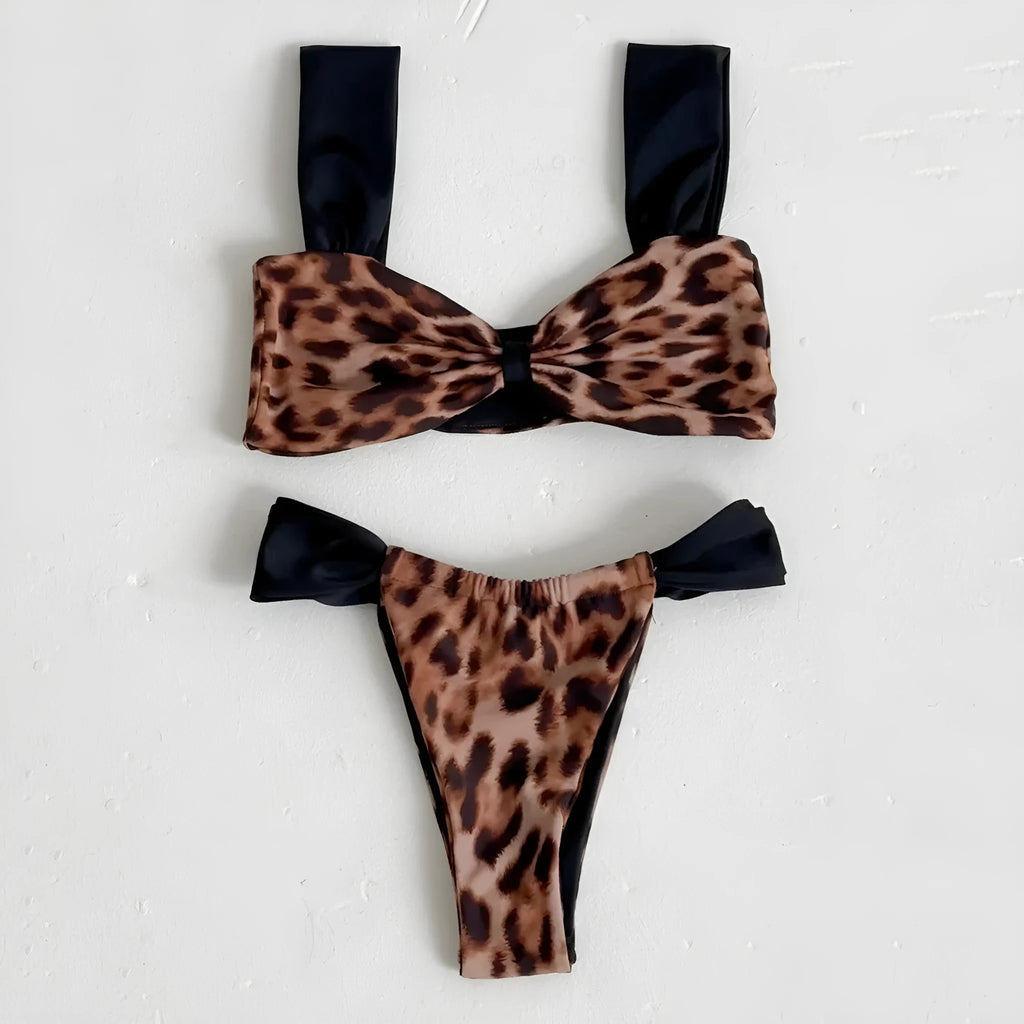 Women's black and leopard print tube top bikini set laid flat, showing the sleeveless top and briefs.