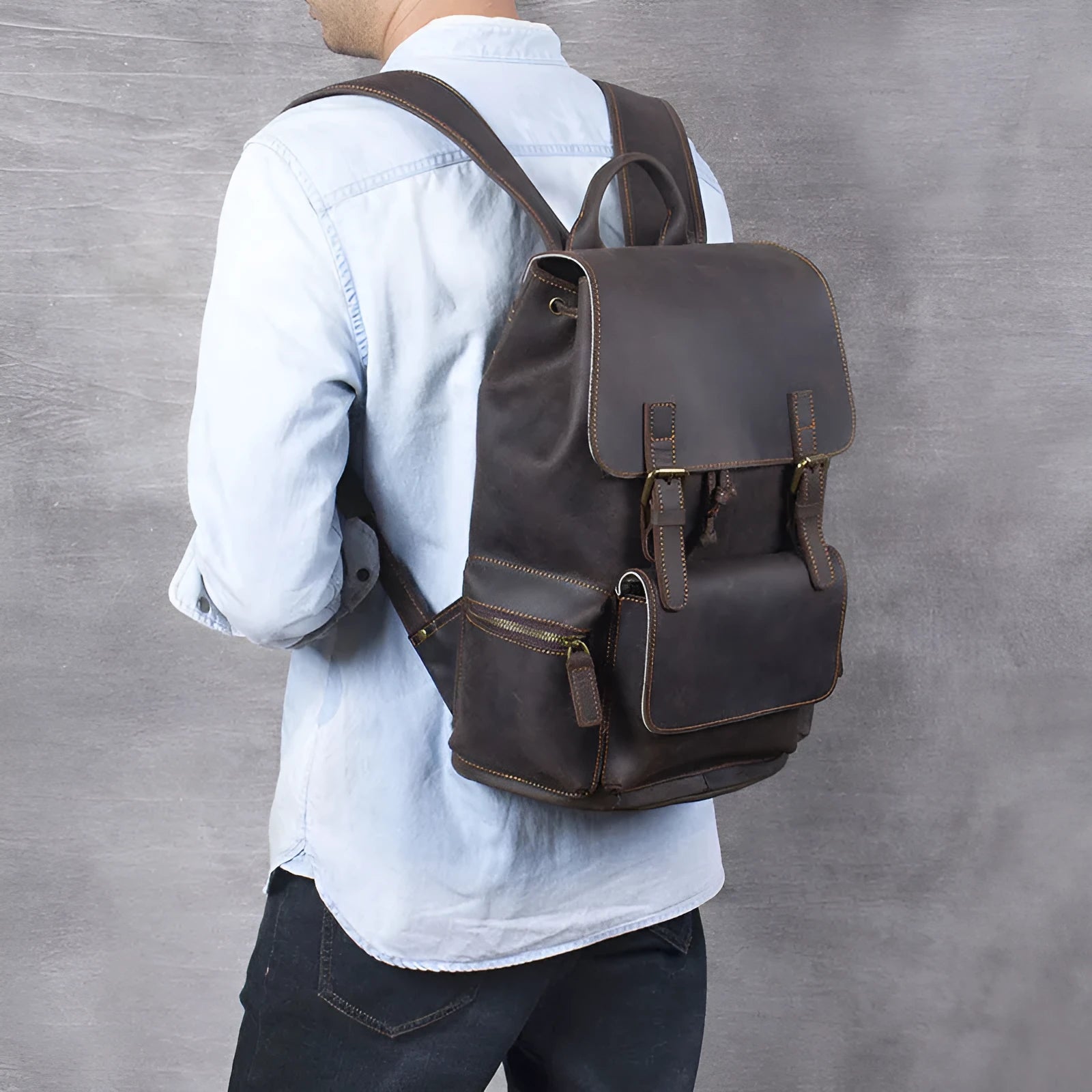 Brown crazy horse leather backpack with denim lining and double shoulder straps.