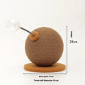 Natural hemp rope cat scratch board with attached toy ball on a wooden floor.