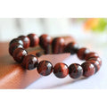 Wood alexandrite bracelet with red tigereye lightning cat's eye pattern and geometric round beads
