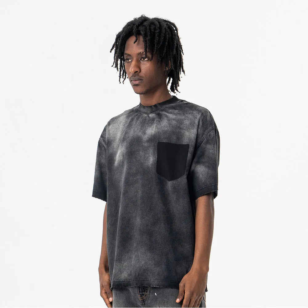 Black loose-fit men's cotton t-shirt with drop-shoulder sleeves on a grey background.