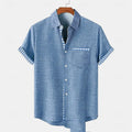 Linen short-sleeve T-shirt with a blue ocean fish design on the lapel, shown in a loose casual fit.