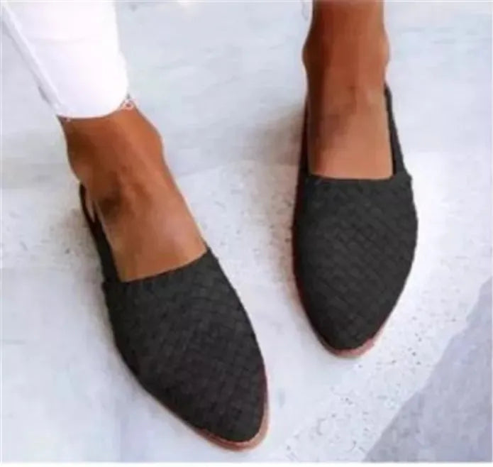 A pair of pointed-toe baotou flat sandals with an adjustable buckle strap, shown in a dark brown colour.