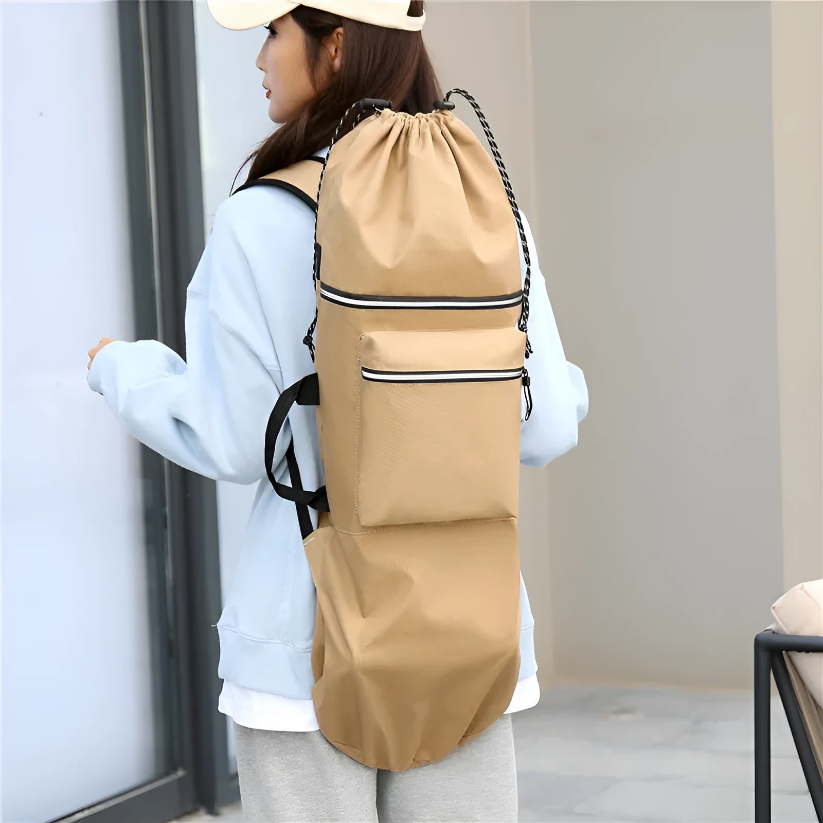 Black waterproof nylon skateboard duffel bag with long main compartment for a 90cm board or fishing rods.