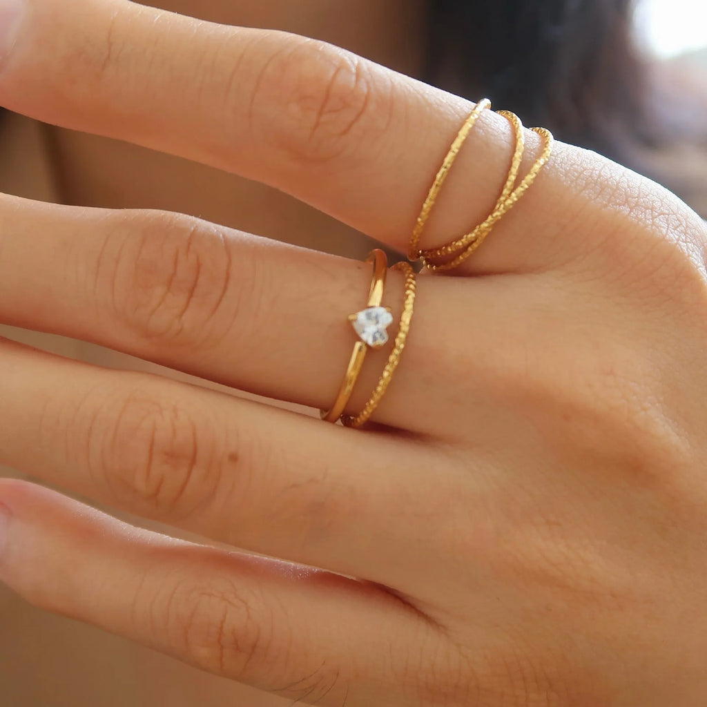 Golden stainless steel love heart ring with an oval ring bath design.